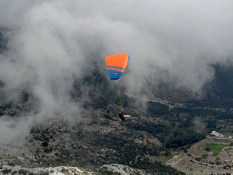A wing flying among clouds