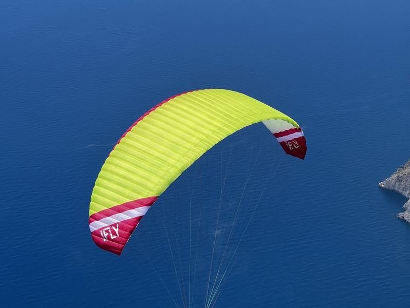 A yellow wing flying over the sea
